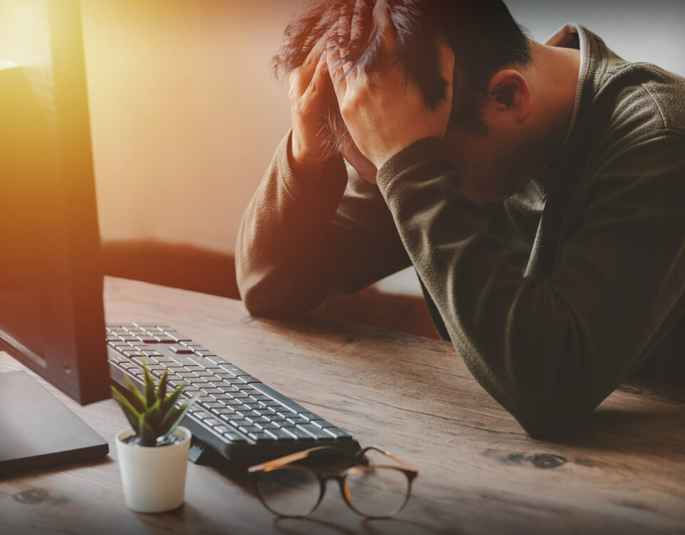 Businessman holding his head and feeling stressed